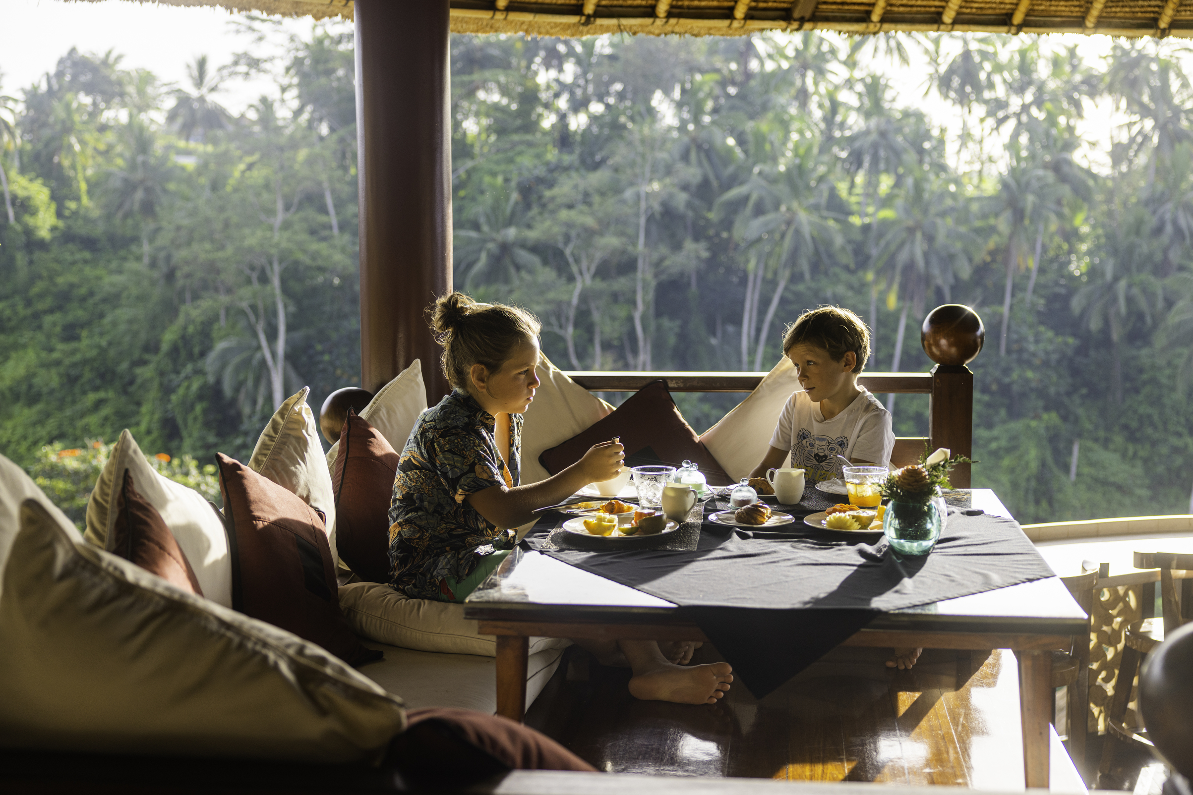 Two kids sitting at a resort in Bali