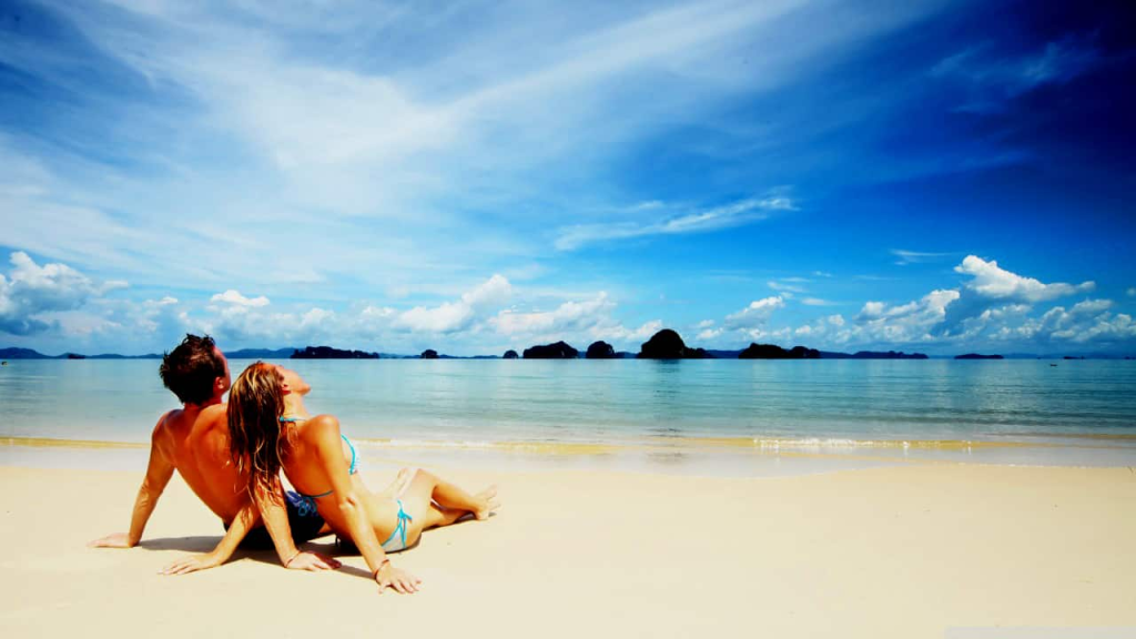 A couple on their honeymoon relaxing on a beach