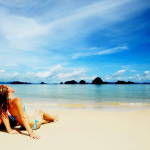 A couple on their honeymoon relaxing on a beach