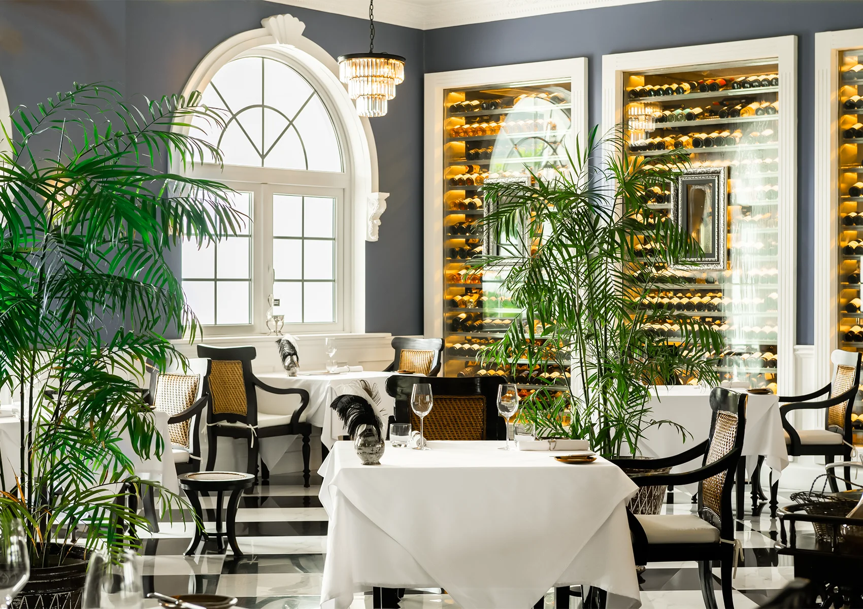 Elegant dining ambience at Apéritif Restaurant in Viceroy Bali with sophisticated interior design, fine dining tables, and a luxury romantic atmosphere overlooking the hidden resort in Ubud