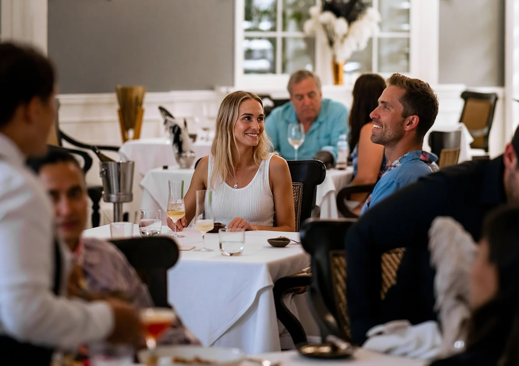 Couple enjoying a romantic fine dining experience at Apéritif Restaurant in Viceroy Bali with elegant luxury interiors, gourmet cuisine, and an intimate dinner atmosphere in Ubud