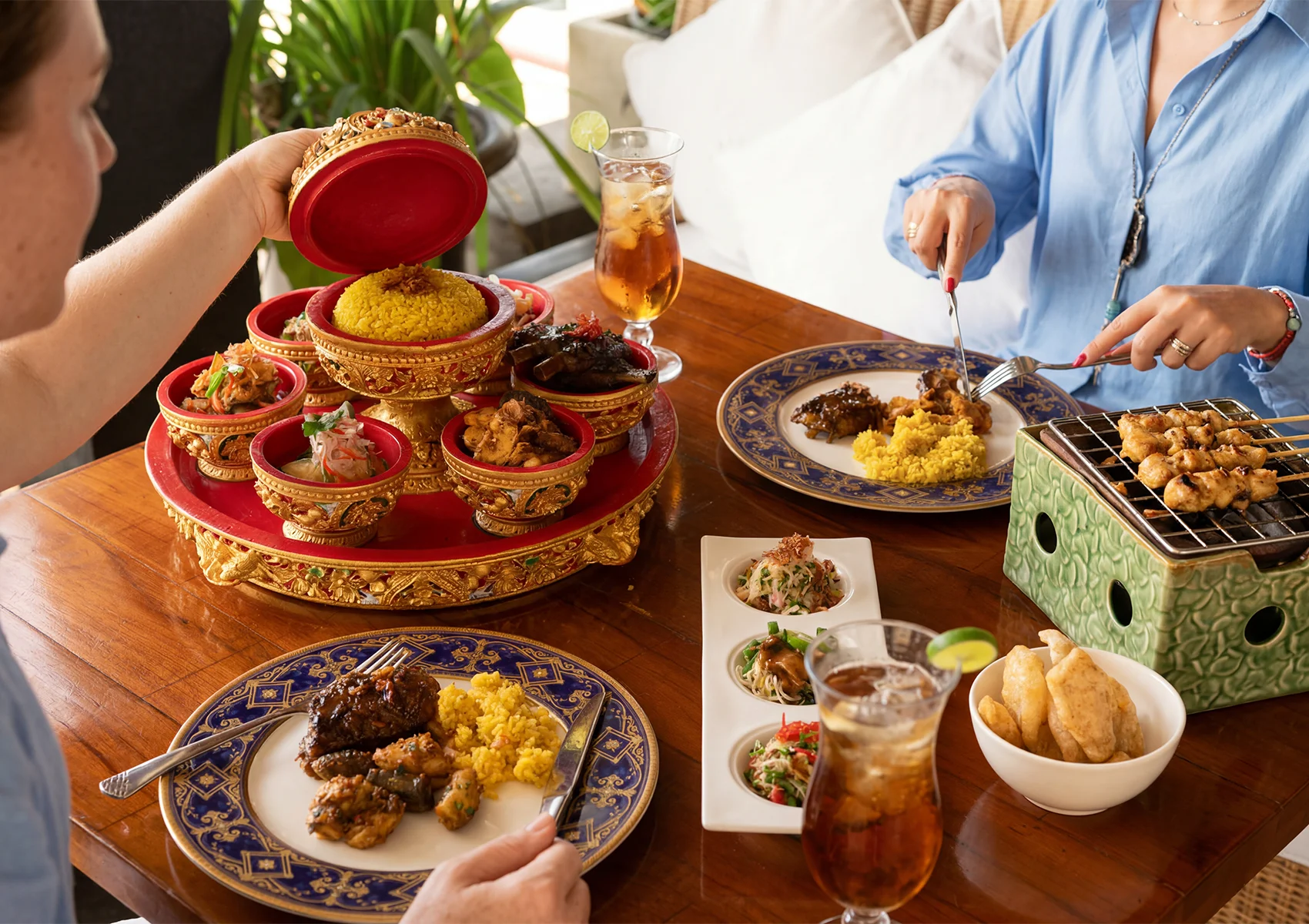 Traditional Balinese rijsttafel dining experience in Ubud with Indonesian sharing dishes and satay skewers