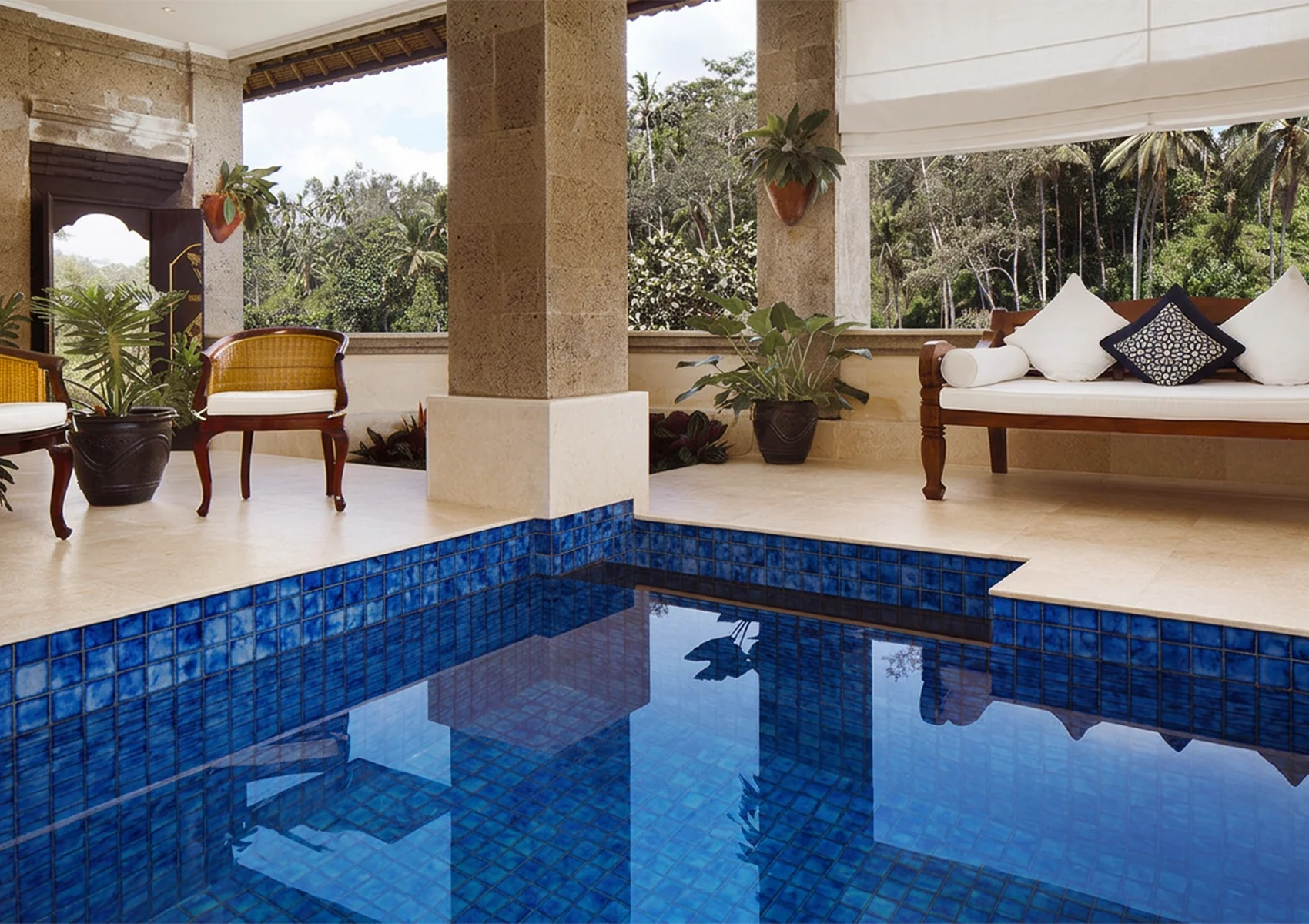 Private pool suite at Viceroy Bali featuring a luxurious blue-tiled plunge pool, elegant Balinese design, open-air lounge area, and peaceful jungle views for a romantic couples getaway in Ubud