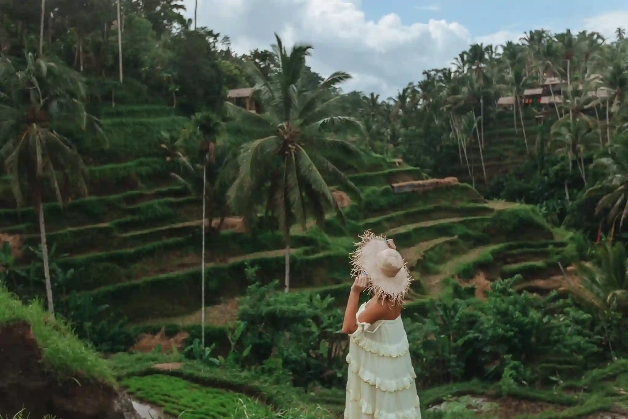 A girl walks on rice terraces in Bali